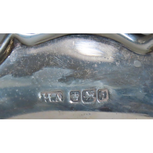 596 - AN OVAL SILVER BREAD BASKET, scroll edge form, raised on an oval foot, marked Atkin Bros, Sheffield,... 