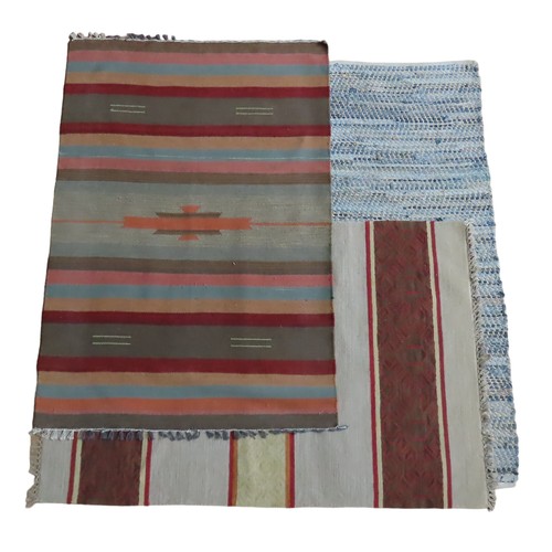 79 - AN INDIAN FLATWEAVE RUNNER AND TWO DHURRIE FLAT WEAVE RUGS, in a variety of colours, in the followin... 