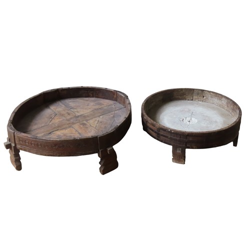 29 - TWO INDIAN TEAK CHAKKI TABLES, the larger pegged example with carved roundel decoration, the smaller... 