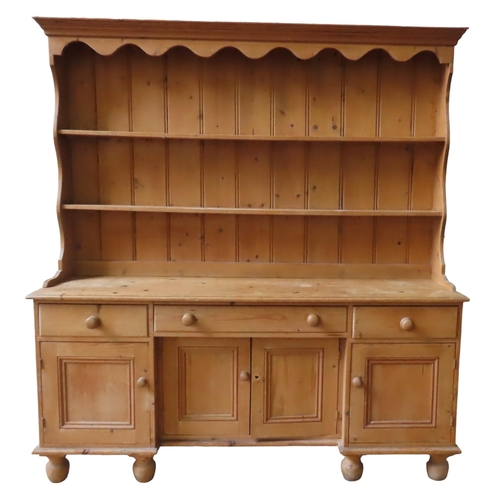 37 - A WAXED PINE KITCHEN DRESSER, 19TH CENTURY, consisting of a two tier plate rack sat atop a dresser b... 