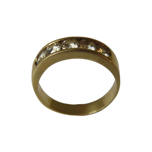 563 - A GOLD RING SET WITH FIVE BRILLIANT CUT DIAMONDS, set within a recessed mount, the shank stamped 18k... 