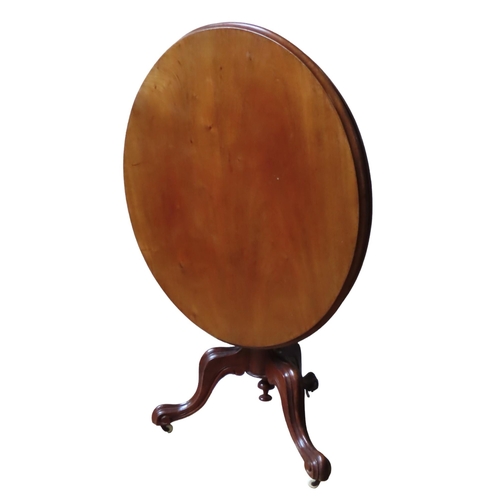 45 - A VICTORIAN MAHOGANY TRIPOD TABLE, the moulded edge circular tilting top raised on a turned baluster... 