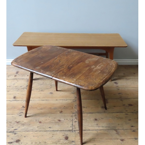 5 - AN ERCOL MODEL 213 OCCASIONAL TABLE, curved edge rectangular elm top on tapering beech legs (48 x 68... 