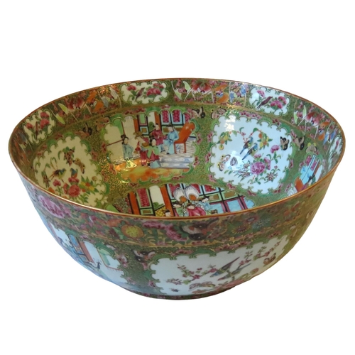 210 - A CANTONESE PUNCH BOWL OF TYPICAL DECORATION, the centre decorated with a  court scene, 19th century... 