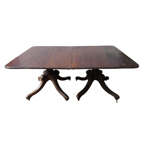 70 - A 19TH CENTURY MAHOGANY TWIN PEDESTAL DINING TABLE, the rectangular top comprised of two tilt-top se... 