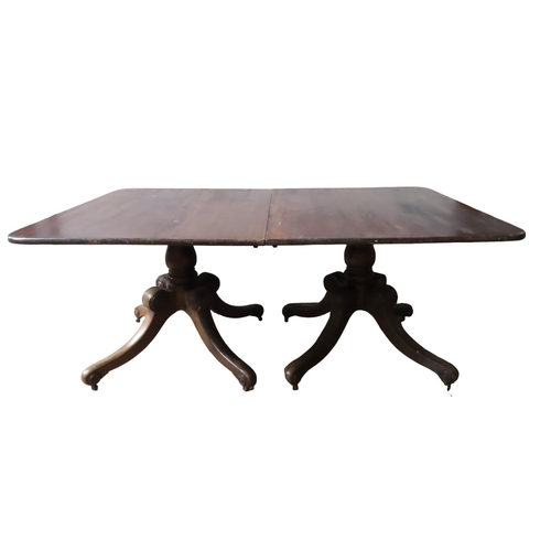 70 - A 19TH CENTURY MAHOGANY TWIN PEDESTAL DINING TABLE, the rectangular top comprised of two tilt-top se... 