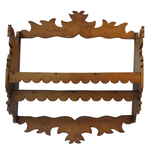 41 - A FRENCH FRUITWOOD WALL MOUNTED SHELF, 19TH CENTURY, the ornate fret carved shelf decorated with twi... 