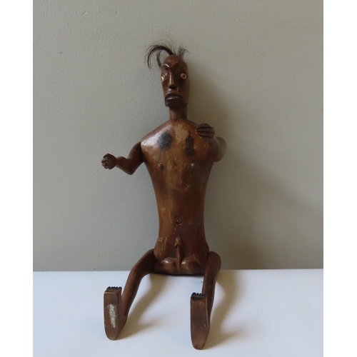 619 - AN AFRICAN ARTICULATED WOODEN MALE FERTILITY FIGURE with tufted hair and bone inset eyes.40 cms... 