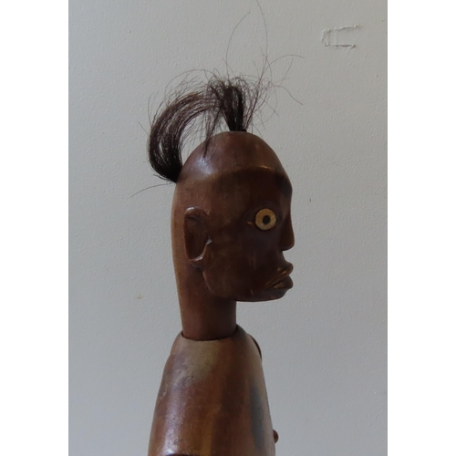 619 - AN AFRICAN ARTICULATED WOODEN MALE FERTILITY FIGURE with tufted hair and bone inset eyes.40 cms... 