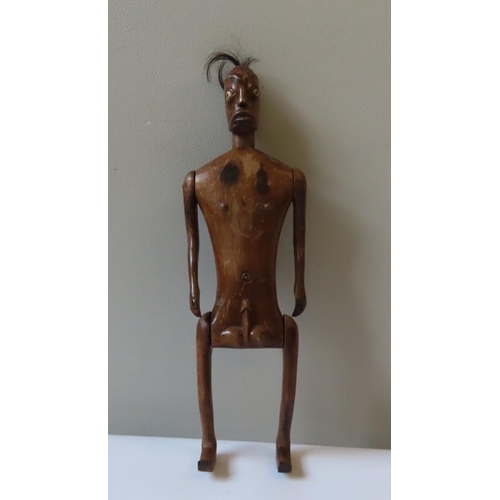 619 - AN AFRICAN ARTICULATED WOODEN MALE FERTILITY FIGURE with tufted hair and bone inset eyes.40 cms... 