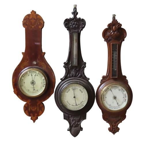 94 - THREE ANEROID BAROMETERS, LATE 19TH/EARLY 20TH CENTURY, two in carved oak banjo form cases, one in a... 