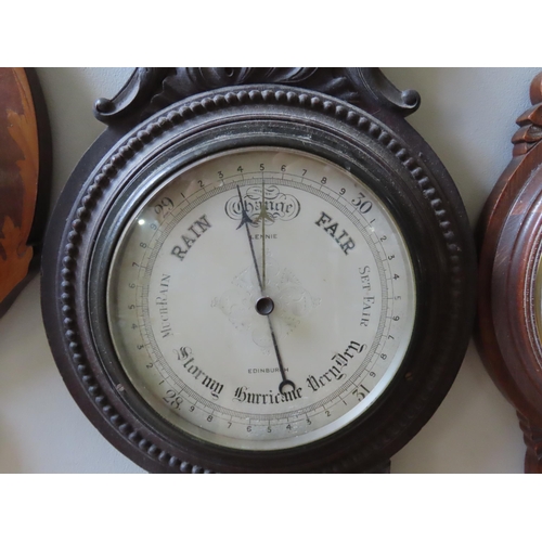 94 - THREE ANEROID BAROMETERS, LATE 19TH/EARLY 20TH CENTURY, two in carved oak banjo form cases, one in a... 