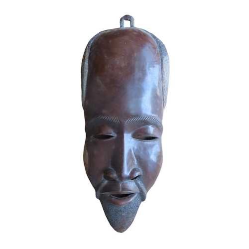 87 - A LARGE AFRICAN CARVED WOODEN MASK. made for the decorative market98 cms high