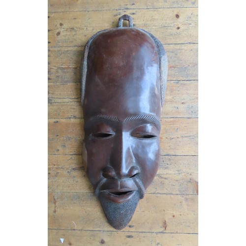 87 - A LARGE AFRICAN CARVED WOODEN MASK. made for the decorative market98 cms high