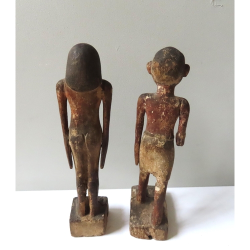 621 - A PAIR OF ANCIENT EGYPTIAN STYLE CARVED WOODEN FIGURES of a standing man and Woman.40 cms high.... 