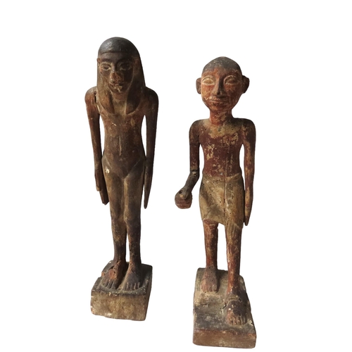 621 - A PAIR OF ANCIENT EGYPTIAN STYLE CARVED WOODEN FIGURES of a standing man and Woman.40 cms high.... 