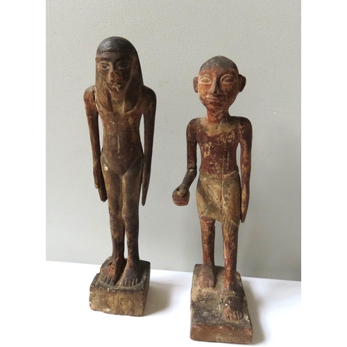 621 - A PAIR OF ANCIENT EGYPTIAN STYLE CARVED WOODEN FIGURES of a standing man and Woman.40 cms high.... 