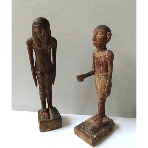 621 - A PAIR OF ANCIENT EGYPTIAN STYLE CARVED WOODEN FIGURES of a standing man and Woman.40 cms high.... 