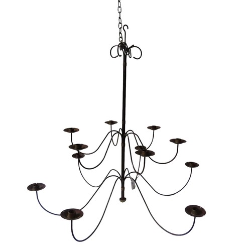 332 - A VINTAGE WROUGHT IRON CHANDELIER, comprised of twelve sconces on scrolling arms, arranged on two ti... 