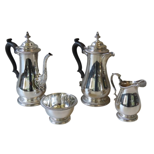 598 - A FOUR PIECE SILVER PART SERVICE, comprised of a coffee pot, hot water jug, milk jug and sugar bowl,... 