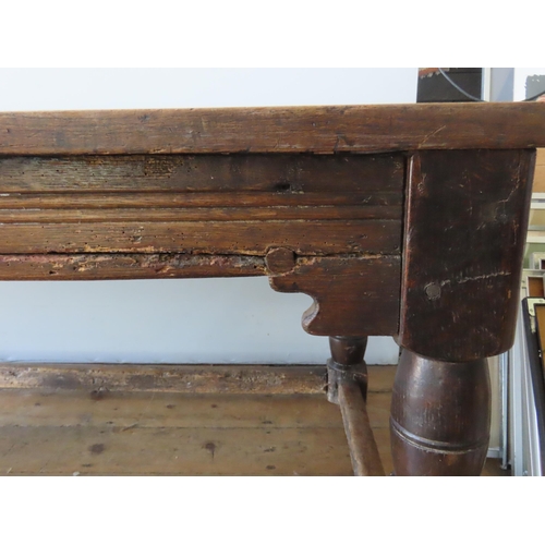 67 - AN 18TH CENTURY OAK REFECTORY TABLE, with quadruple boarded removable top over frieze panels with ru... 