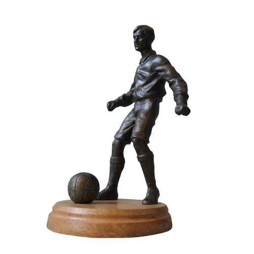 582 - A BRONZE FIGURE OF A FOOTBALL PLAYER, MID 20TH CENTURY, modelled naturalistically, about to strike t... 