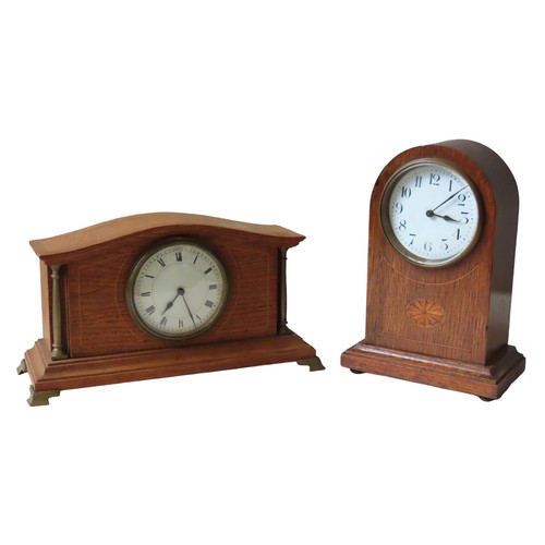 173 - TWO OAK LINE INLAID MANTEL CLOCKS, EARLY 20TH CENTURY, one in an arch case with a 80 mm white enamel... 