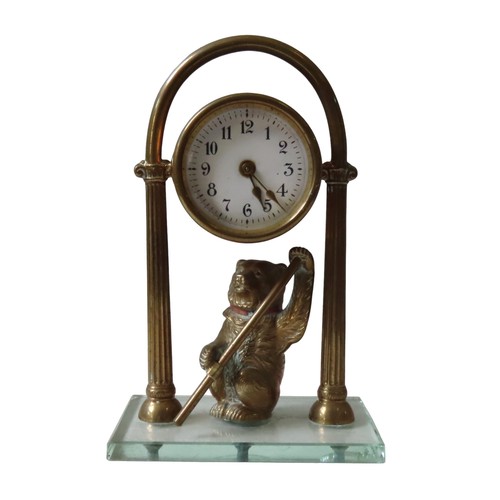 182 - A VINTAGE BRASS MANTEL CLOCK, the brass drum case with a 45 mm white enamel dial, supported on an ar... 