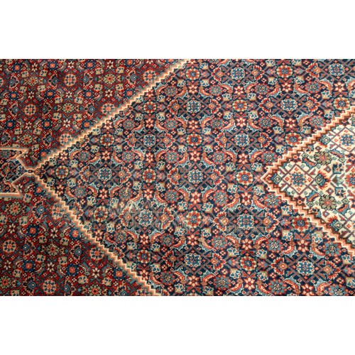 157 - A LARGE HAND WOVEN BIDJAR CARPET, central lozenge form medallion enclosed by alternating red and blu... 