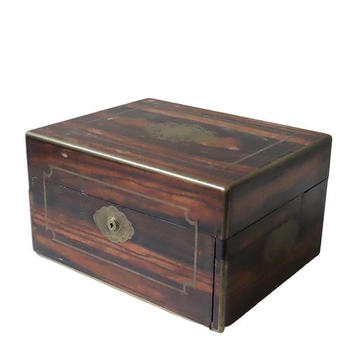 218 - A ROSEWOOD AND BRASS BOUND VANITY BOX, 19TH CENTURY, by Austin of Dublin, with a fall front panel, s... 