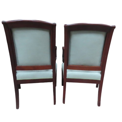 27 - A PAIR OF FRENCH EMPIRE ARMCHAIRS, curved top rail over upholstered back and seat panels, covered in... 