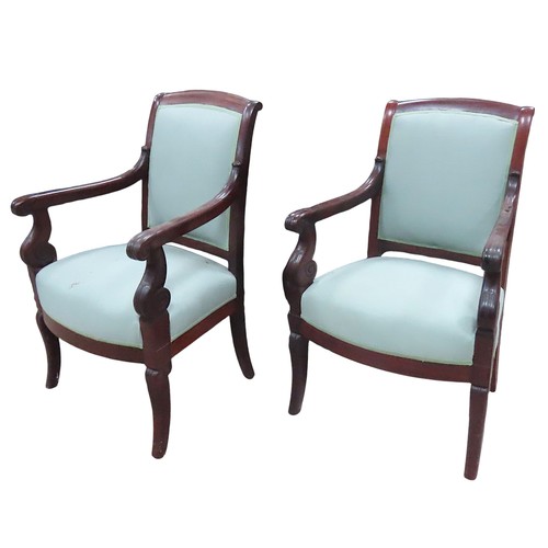 27 - A PAIR OF FRENCH EMPIRE ARMCHAIRS, curved top rail over upholstered back and seat panels, covered in... 