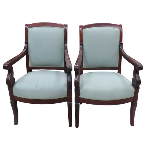 27 - A PAIR OF FRENCH EMPIRE ARMCHAIRS, curved top rail over upholstered back and seat panels, covered in... 