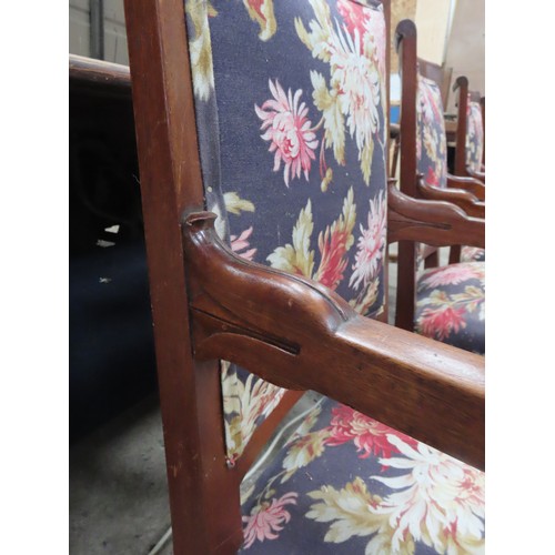 65 - A SET OF FOUR FRENCH EMPIRE ARMCHAIRS, the back and seat panels covered in a vibrant floral patterne... 