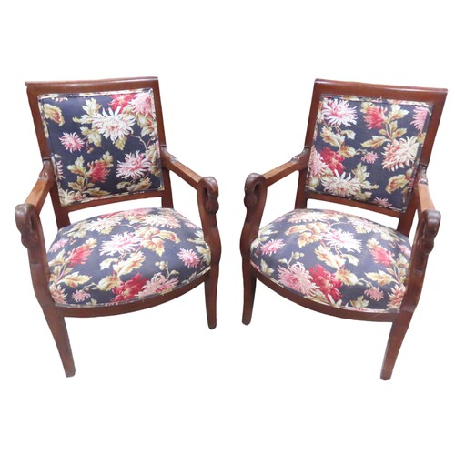 65 - A SET OF FOUR FRENCH EMPIRE ARMCHAIRS, the back and seat panels covered in a vibrant floral patterne... 