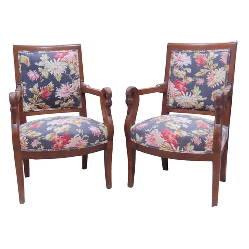 65 - A SET OF FOUR FRENCH EMPIRE ARMCHAIRS, the back and seat panels covered in a vibrant floral patterne... 