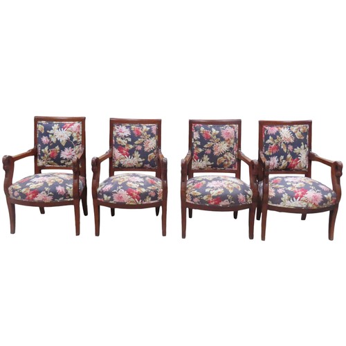 65 - A SET OF FOUR FRENCH EMPIRE ARMCHAIRS, the back and seat panels covered in a vibrant floral patterne... 