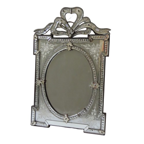 207 - A VINTAGE VENETIAN MIRROR, the bevelled oval plate within a beaded slip, the square form etched fram... 