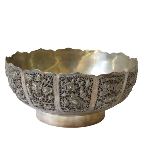 674 - A CHINESE WHITE METAL LOTUS FORM BOWL, the sides decorated in high relief with birds perched amongst... 