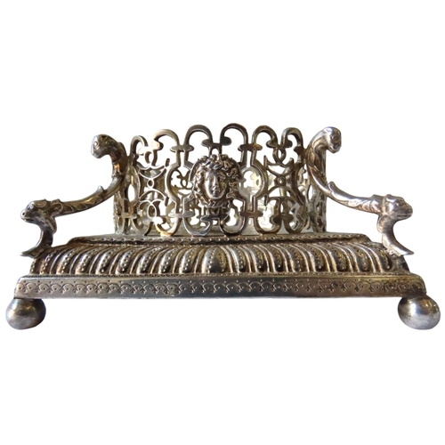 699 - AN ORNATE GEORGE II SILVER BOTTLE STAND, a pierced circular lattice gallery adorned with Neo Classic... 