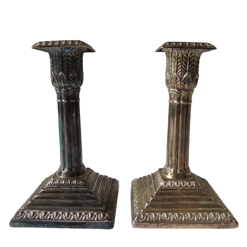 659 - A PAIR OF VICTORIAN SILVER CANDLESTICKS, square gardrooned sconces raised on fluted stiff leaf decor... 