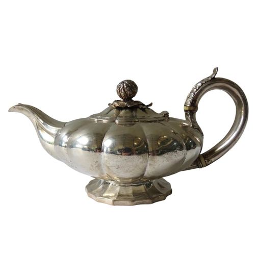 704 - A GEORGE IV SILVER TEAPOT, compressed melon form with C-scroll foliate decorated handle, the hinged ... 