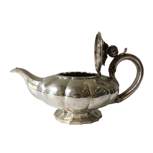 704 - A GEORGE IV SILVER TEAPOT, compressed melon form with C-scroll foliate decorated handle, the hinged ... 