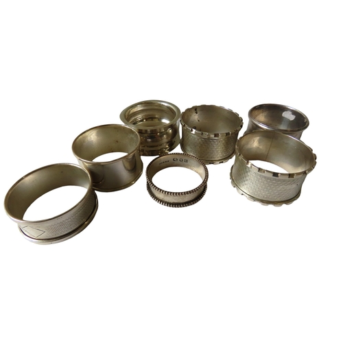 625 - A MIXED GROUP OF SEVEN VINTAGE SILVER NAPKIN RINGS, various marks and dates, including three with en... 