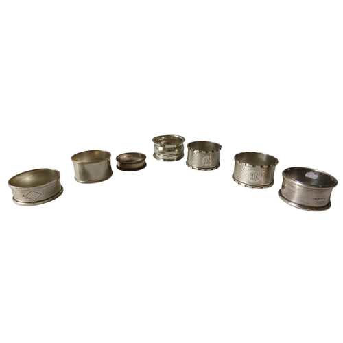 625 - A MIXED GROUP OF SEVEN VINTAGE SILVER NAPKIN RINGS, various marks and dates, including three with en... 