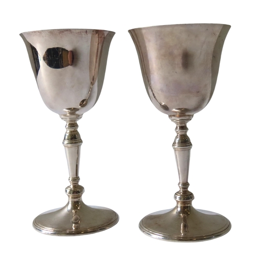 685 - A PAIR OF VINTAGE SILVER GOBLETS, the flared edge bowls raised on knop turned tapering stems, on a c... 