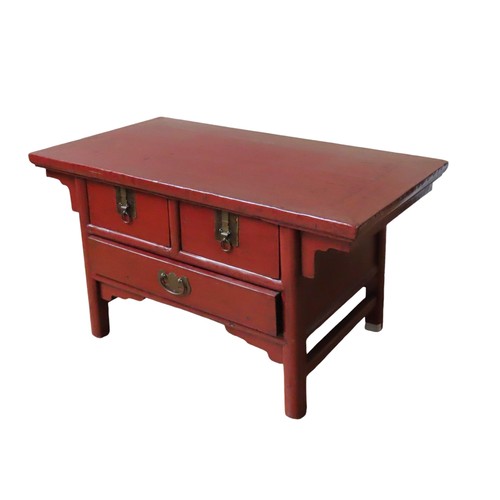 110 - A CHINESE RED LACQUER TABLE , rectangular top over two short drawers and one long frieze drawer, rai... 