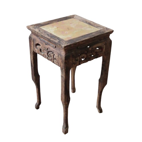 104 - A CARVED CHINESE MARBLE INSET STAND, the square form top with peach coloured slab, above a scroll ca... 