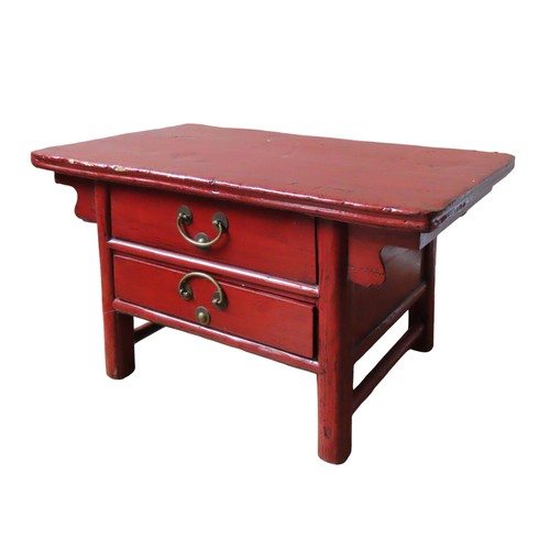 113 - A CHINESE RED LACQUER TABLE, rectangular top with scrolling angle brackets, over two frieze drawers,... 