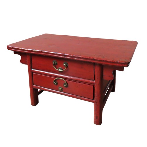 113 - A CHINESE RED LACQUER TABLE, rectangular top with scrolling angle brackets, over two frieze drawers,... 